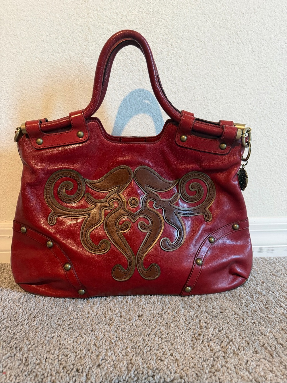 Red Leather Shoulder Bag with Decorative Brown Appliqué